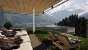 a patio with chairs and a view of a mountain at Das.Goldberg in Bad Hofgastein