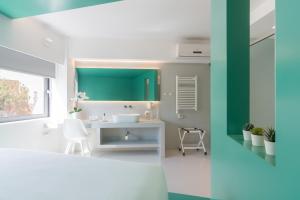 La salle de bains est pourvue d'un lavabo blanc et d'un mur vert. dans l'établissement Athens Color Cube, à Athènes