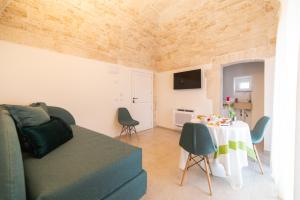 a room with a bed and a table and chairs at San Matteo Dimore di Charme in Putignano