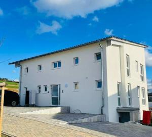 a large white building with a garage at Apartment Weikersheim V in Weikersheim