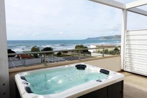 a bath tub with a view of the ocean at Hotel e Residence Il Faro Acciaroli in Acciaroli
