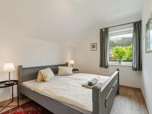 a bedroom with a large bed with a window at Spacious Apartment in Katschberg in Sankt Michael im Lungau