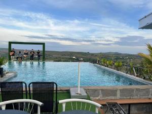 a group of people standing around a swimming pool at Hotel Stylish Binh Long in Thanh Bình