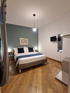 a bedroom with a bed and a blue wall at U Genova in Genova