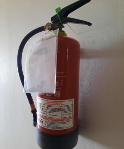 a fire extinguisher with a tag on top of it at SPOT ON 93853 Budi Residence 2 in Bekasi