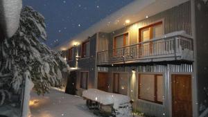 a building covered in snow at night at Ukurj Apartamentos in Ushuaia