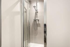 a shower with a glass door in a bathroom at Comfortable 1 Bedroom Apartment in Central Doncaster in Doncaster