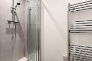 a shower with a glass door in a bathroom at Cosy 1 Bedroom Apartment in Central Doncaster in Doncaster