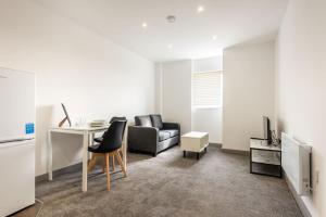 a living room with a desk and a couch at Cosy 1 Bedroom Apartment in Central Doncaster in Doncaster