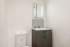 a bathroom with a toilet and a sink at Comfortable Studio Apartment in Central Doncaster in Doncaster