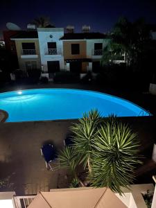 an overhead view of a swimming pool at night at Apartament Cosy House with pool, Paphos Pafos,Tombs of Kings in Paphos