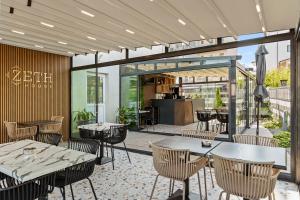 a restaurant with tables and chairs in a patio at ZETH HOUSE in Mamaia Sat/Năvodari