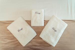 two white towels sitting on top of a bed at Palace of Culture & Palas Mall Collection Suites & Studios in Iaşi