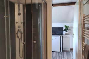 a glass shower door in a room with a desk at Studio lumineux Entrée privée Bocage Normand in Moncy +21 photos