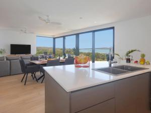 a kitchen and living room with a view of the ocean at Hermosa Bay Oceanview Villa in Boca Chica