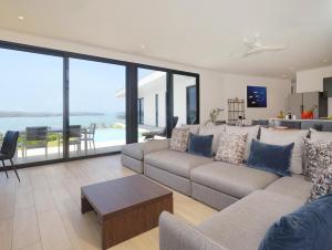 a living room with a couch and a table at Hermosa Bay Oceanview Villa in Boca Chica