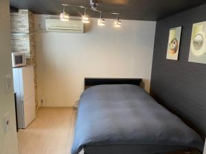 Postel nebo postele na pokoji v ubytování OKAERI築地町