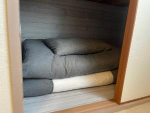 a small room with a bed in a closet at OKAERI築地町 in Takamatsu