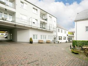 a large white building with a patio in front of it at Apartment with Balcony near the Luxembourg s Border in Bollendorf