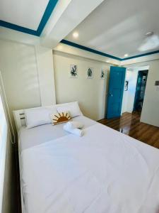 a large white bed in a room with blue ceilings at Caleo Boracay Island Station 3 in Boracay +189 photos