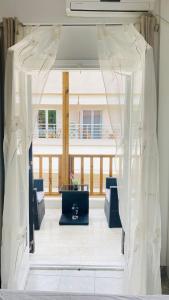 a white curtain in a room with a table at *NEW* BEACHFRONT APARTMENT SEA VIEW in Pefkohori