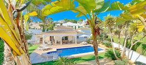 an aerial view of a house with a swimming pool and palm trees at Villa Sollero by Solidays in Moraira