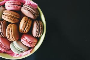 a bowl of macaroons and pastries at Hotel Rose Inn - Dwarka Sec 8 in New Delhi