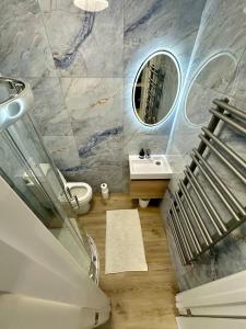 een badkamer met een wastafel en een spiegel bij Finsbury Park Studios in Londen