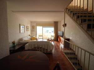 ein Schlafzimmer mit einem Bett und einer Treppe in der Unterkunft CABIONI - casa adosada con piscina comunitaria, cerca de la playa de Grifeu. - ES-228-39 in Llança + 25 Fotos