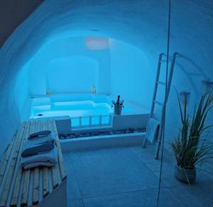 a room with a tub with a bench and a blue light at Loveroom La Cesarine Jacuzzi privé in Mougins +22 photos