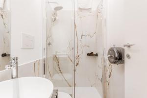a white bathroom with a shower and a toilet at Casa Roma B&B in Rome