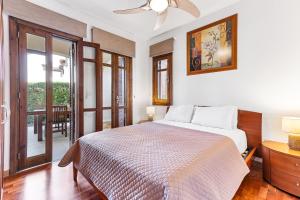 a bedroom with a bed and a sliding glass door at 2 bedroom Apartment Kalypso with private garden, Aphrodite Hills Resort in Kouklia +29 photos