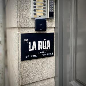 a sign on the side of a building at Pensión La Rúa-Montera in Madrid