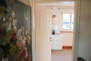 a kitchen with a painting on the wall at Wolfsgrund Villa und/oder Apartment - Luxus in Seenähe mit tollem Garten in Schluchsee +104 photos
