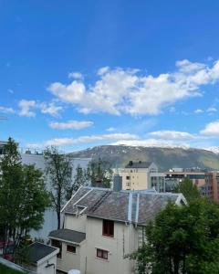 a white house with a view of a body of water at Great 2 bedroom apartment in Tromsø centrum! in Tromsø