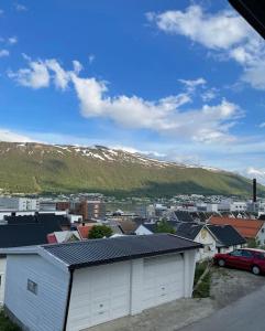 a city with buildings and a mountain in the background at Great 2 bedroom apartment in Tromsø centrum! in Tromsø