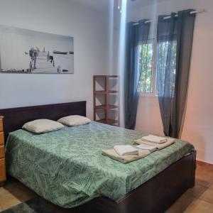 a bedroom with a bed with two towels on it at Girasoles in Chiclana de la Frontera