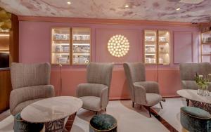 a waiting room with chairs and a table at Grand Poet Hotel and SPA by Semarah in Rīga