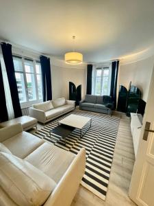 a living room with white couches and a rug at Luxury apartment Times Square district in Paris