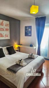 a bedroom with a large bed with a blue curtain at La Chiocciola in Cava deʼ Tirreni