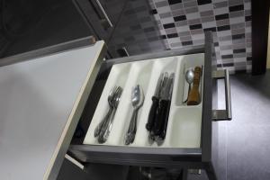 a drawer with silver utensils in a kitchen at Coqueta casita en Tetuán in Madrid