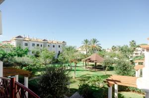 a view of the garden from the balcony of a hotel at Smart La Barrosa in Novo Sancti Petri