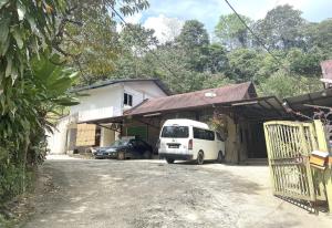 a white van parked in front of a building at OYO 90971 Pollock Homestay in Sungai Lembing