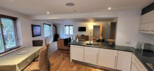 a kitchen and a living room with a counter top at Woodlands in Windermere