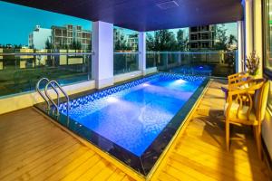 a swimming pool on the roof of a building at Thăng Bình Hotel - FLC Sầm Sơn in Sầm Sơn