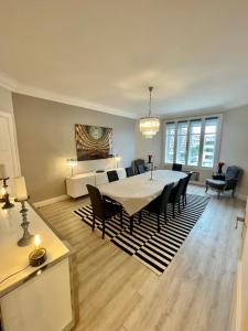 a living room with a dining room table and chairs at Luxury apartment Times Square district in Paris