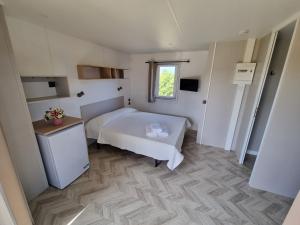 1 dormitorio con cama blanca y ventana en Agriturismo Su Canonigu, en Tortolì