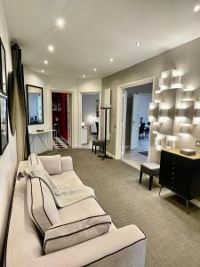 a living room with two white couches and a table at Luxury apartment Times Square district in Paris