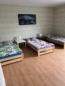 Zimmer mit 3 Betten und einer Wand in der Unterkunft Noclegi w Bardzie in Bardo