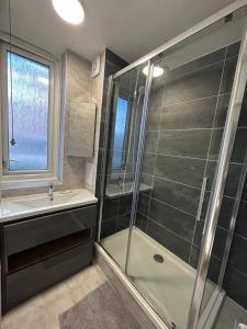W łazience znajduje się prysznic i umywalka. w obiekcie Pass the Keys - Beautiful Flat with balcony in Swiss Cottage, London w Londynie